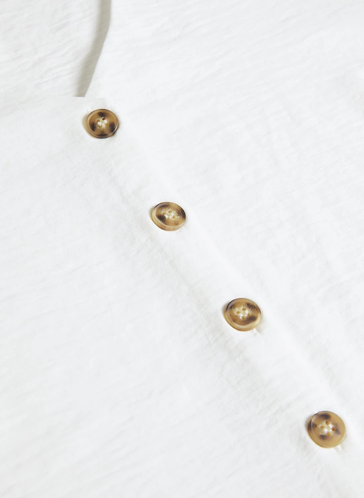 Blouse sans manches boutonnée