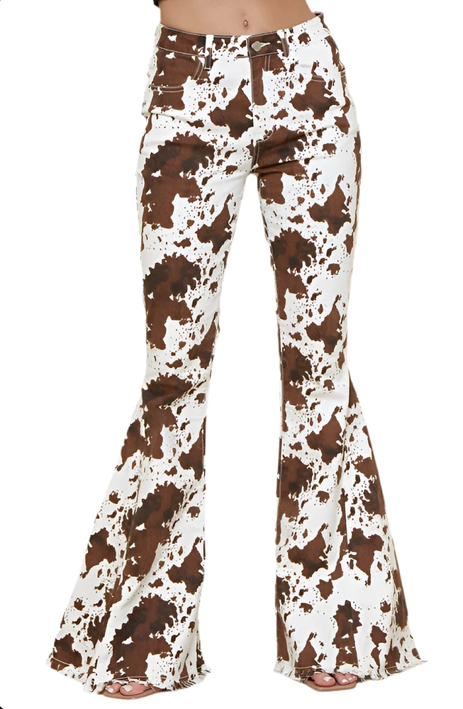 SAINTS AND HEARTS: COW PRINT FLARED DENIM PANTS