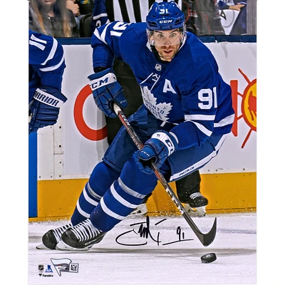 John Tavares Toronto Maple Leafs Autographed 8" x 10" Blue Jersey Skating with Puck Vertical Photograph
