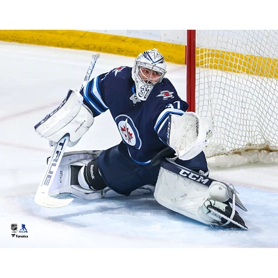 Connor Hellebuyck Winnipeg Jets Unsigned Blue Jersey Glove Save Photograph