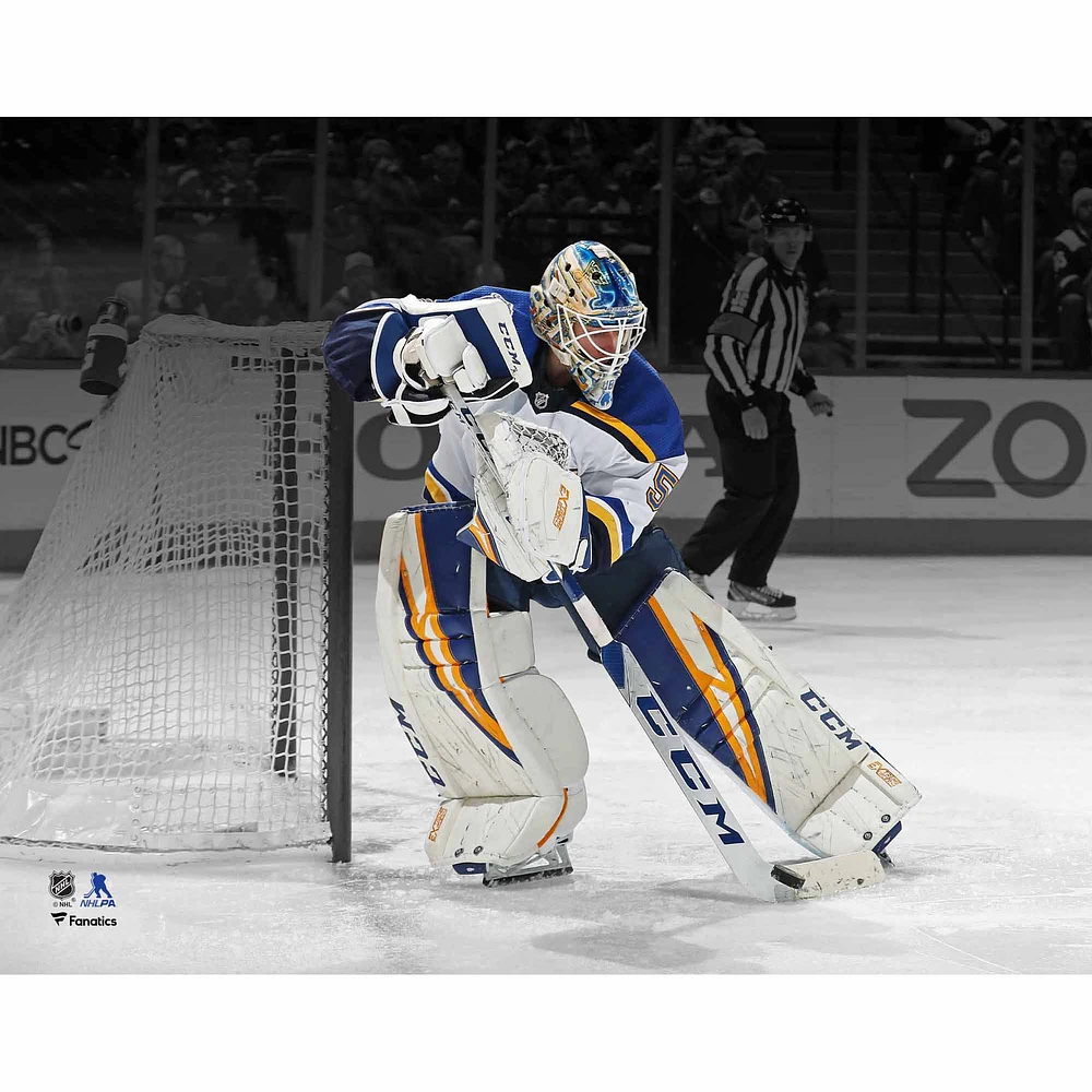 Jordan Binnington St. Louis Blues Unsigned White Jersey Playing Puck Spotlight Photograph