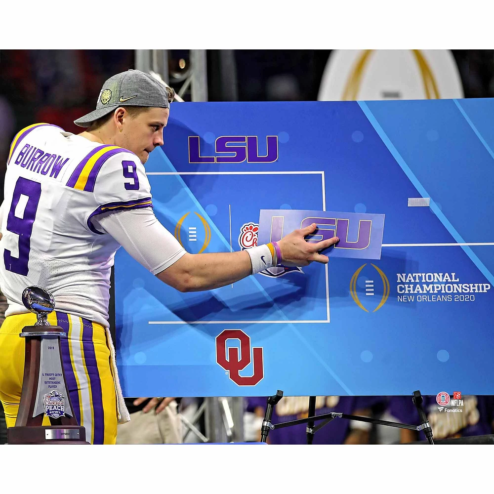 Joe Burrow LSU Tigers Unsigned White Jersey Posting LSU Sticker on National Championship Bracket Photograph