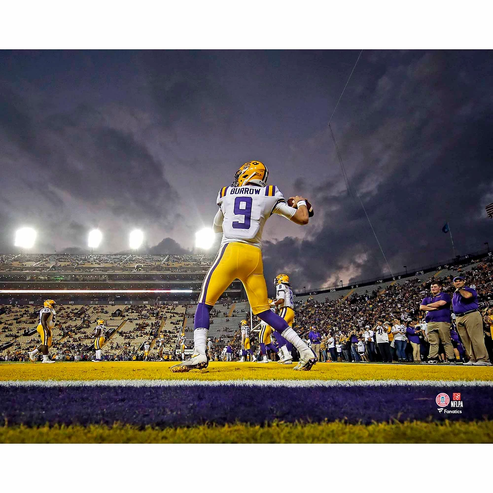 Joe Burrow LSU Tigers Unsigned White Jersey Warming Up At Night Under The Spotlights Photograph