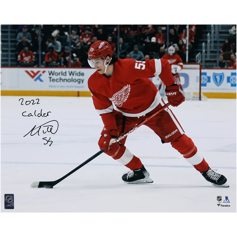 Moritz Seider Detroit Red Wings Autographed 16'' x 20'' 2022 Calder Trophy Winner Red Jersey with Puck Photograph with ''2022 Calder'' Inscription