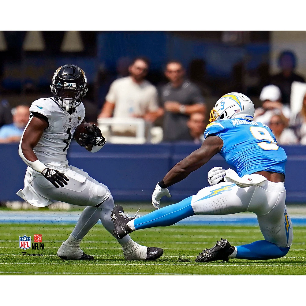 Travis Etienne Jacksonville Jaguars Unsigned Maneuvers Past Defense Photograph