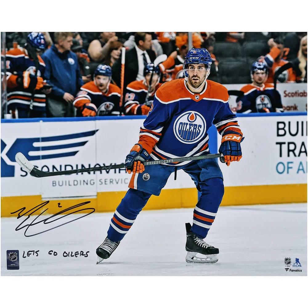 Evan Bouchard Edmonton Oilers Autographed 16" x 20" Blue Jersey Skating Photograph with "Lets Go Oilers!" Inscription