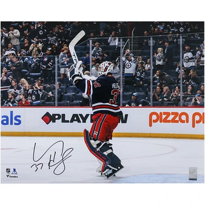 Connor Hellebuyck Winnipeg Jets Autographed 16" x 20" Navy Alternate Jersey Celebration Photograph