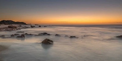 Assaf Frank - Sunset on rocky beach with colorful sky