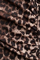 Robe moulante à effet drapé