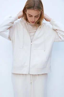 Veste à capuchon glissière