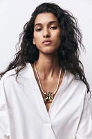 Collier en tissu enduit avec pendentif