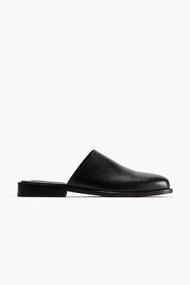 Mules en tissu enduit