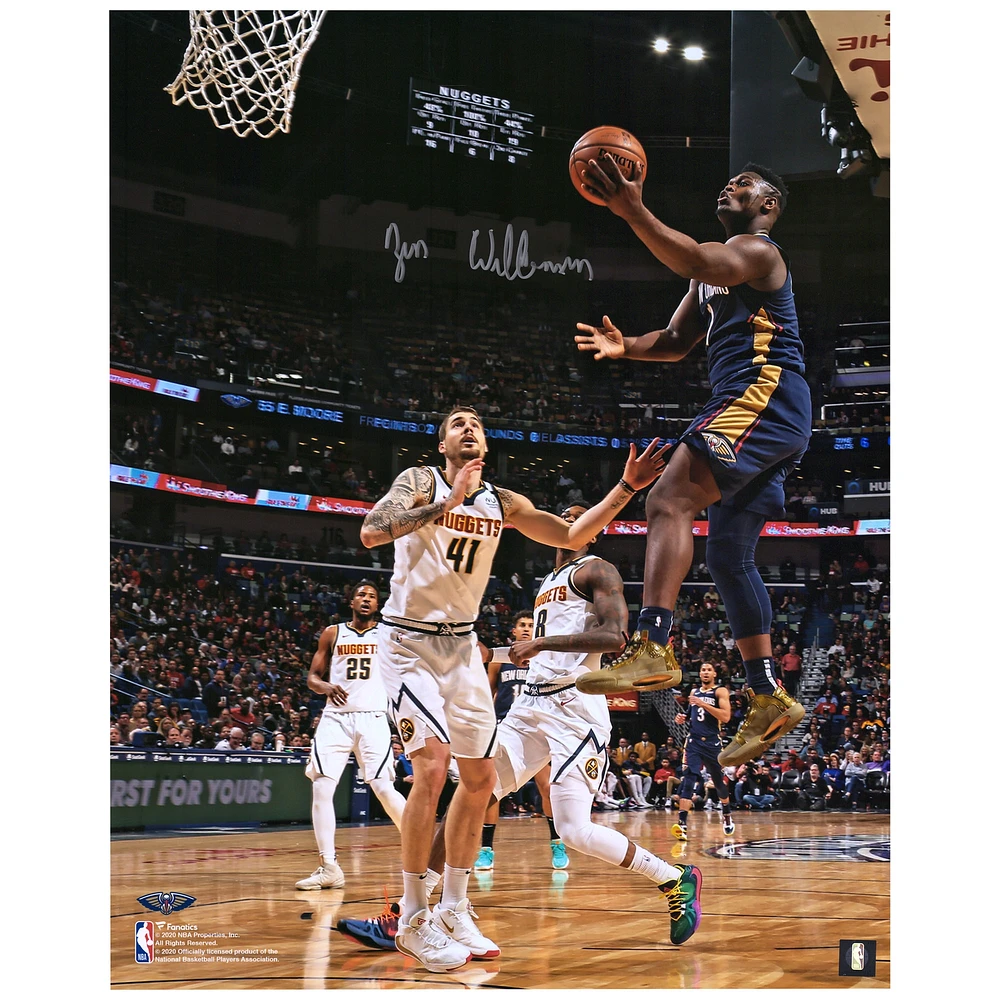 Zion Williamson New Orleans Pelicans Autographed 16" x 20" Navy Jersey Layup Vertical Photograph