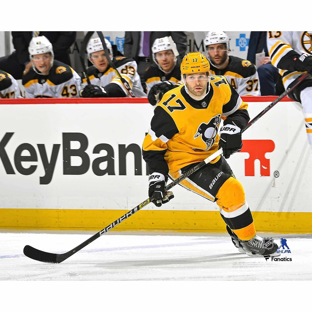Bryan Rust Pittsburgh Penguins Unsigned Gold Alternate Jersey Skating vs. Boston Bruins Photograph