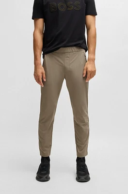 Tapered-leg trousers water-repellent stretch fabric