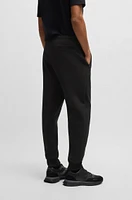 Stretch tracksuit bottoms with logo patch