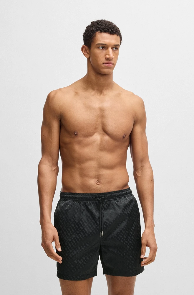 Swim shorts with all-over tonal monograms