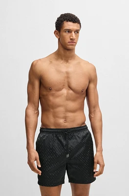 Swim shorts with all-over tonal monograms