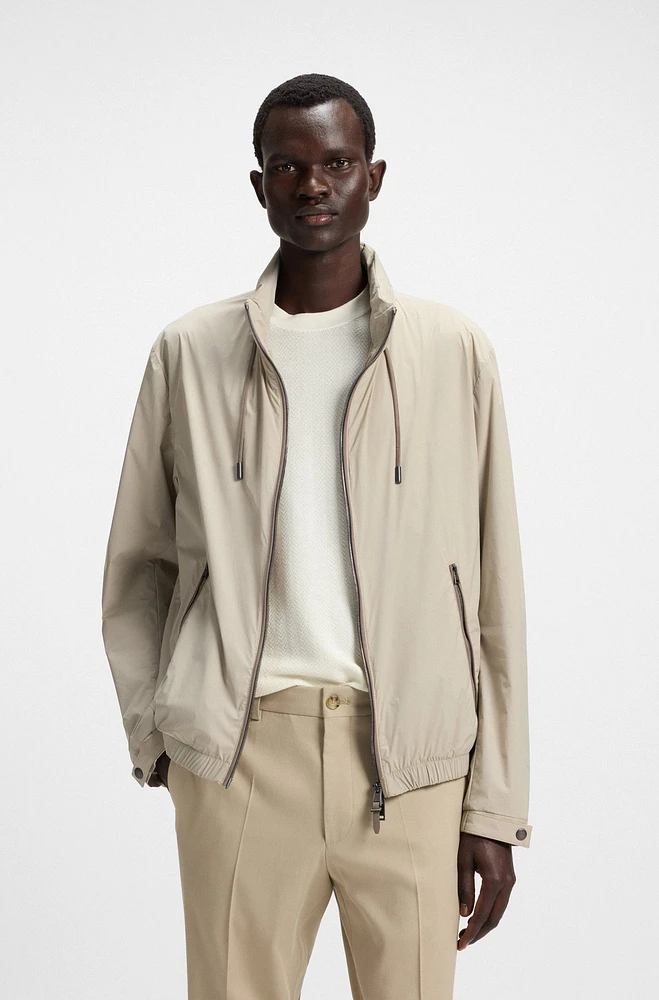 Water-repellent windbreaker with packable hood
