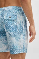 Monogram-artwork swim shorts with logo badge