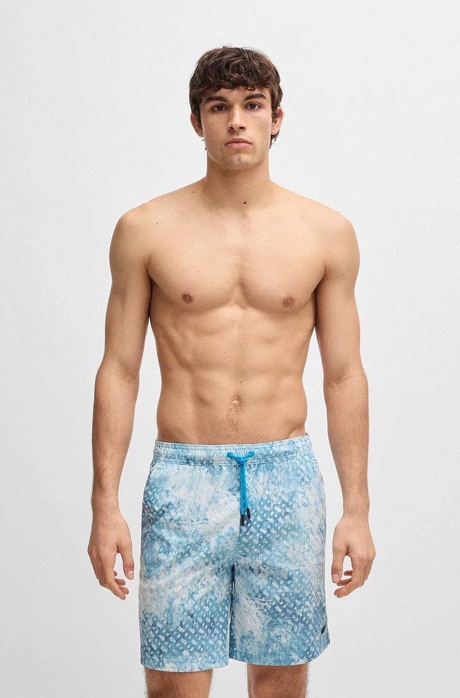 Monogram-artwork swim shorts with logo badge
