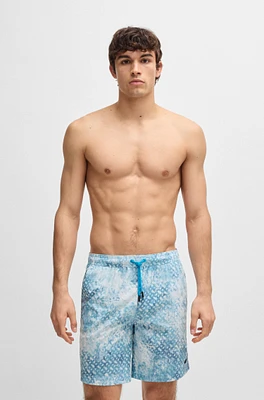 Monogram-artwork swim shorts with logo badge