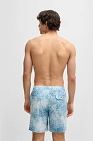Monogram-artwork swim shorts with logo badge