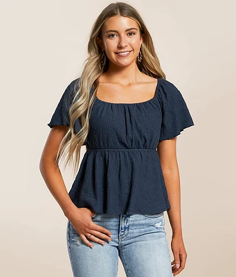 Daytrip Textured Back Tie Peplum Top