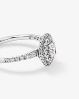 0.58 Carat TW Oval Diamond Halo Baguette Side Accent Engagement Ring in 14kt White Gold