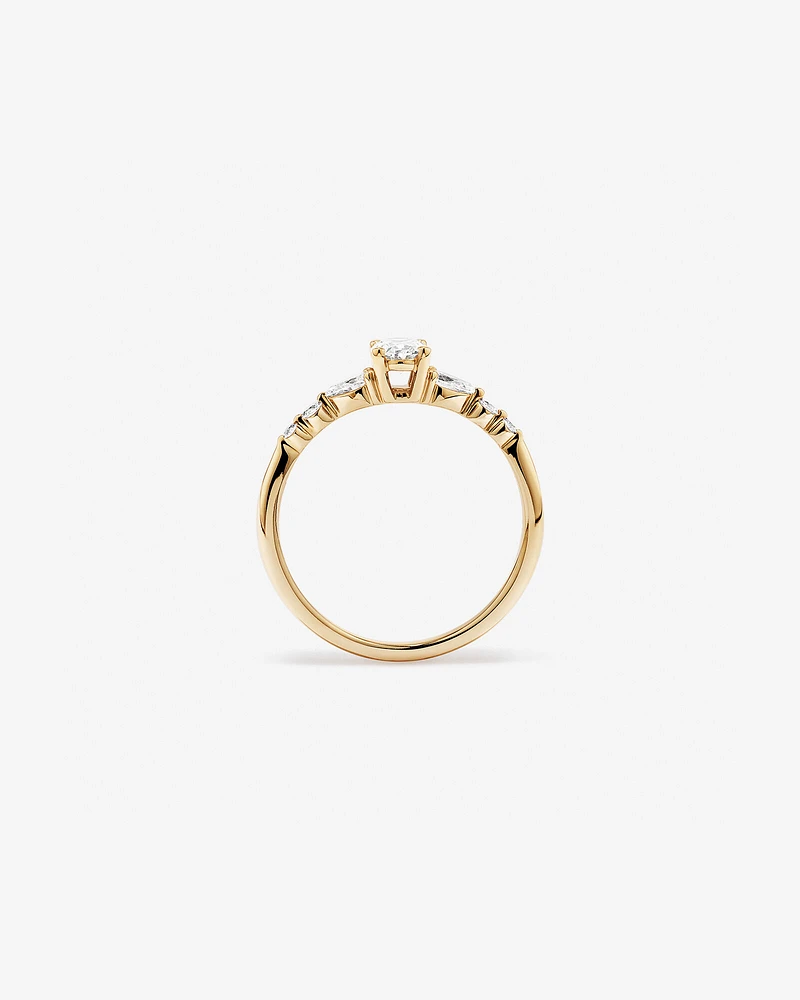 0.59 Carat TW Oval and Pear Sidestone Engagement Ring in 14kt Yellow Gold