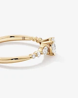 0.59 Carat TW Oval and Pear Sidestone Engagement Ring in 14kt Yellow Gold