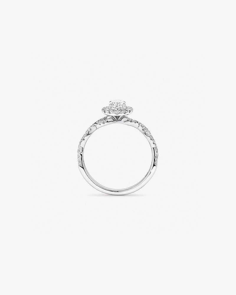 0.75 Carat TW Oval Cut Diamond Twist Side Accent Halo Engagement Ring in 14kt White Gold
