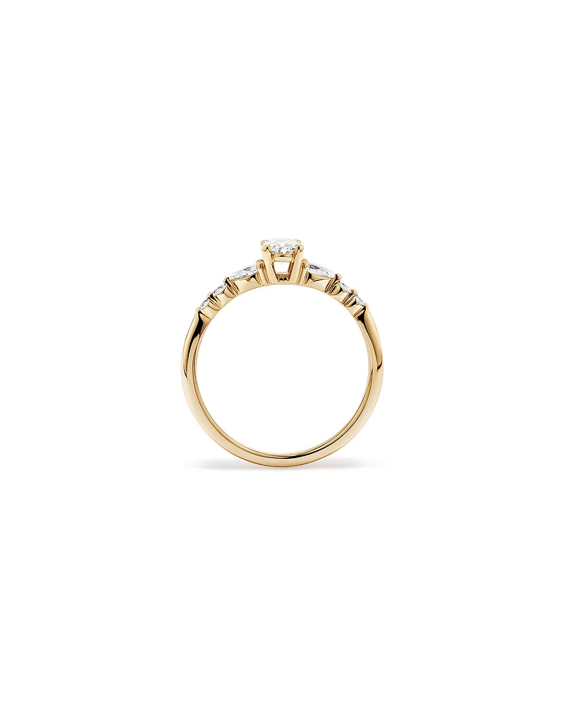 0.59 Carat TW Oval and Pear Sidestone Engagement Ring in 14kt Yellow Gold