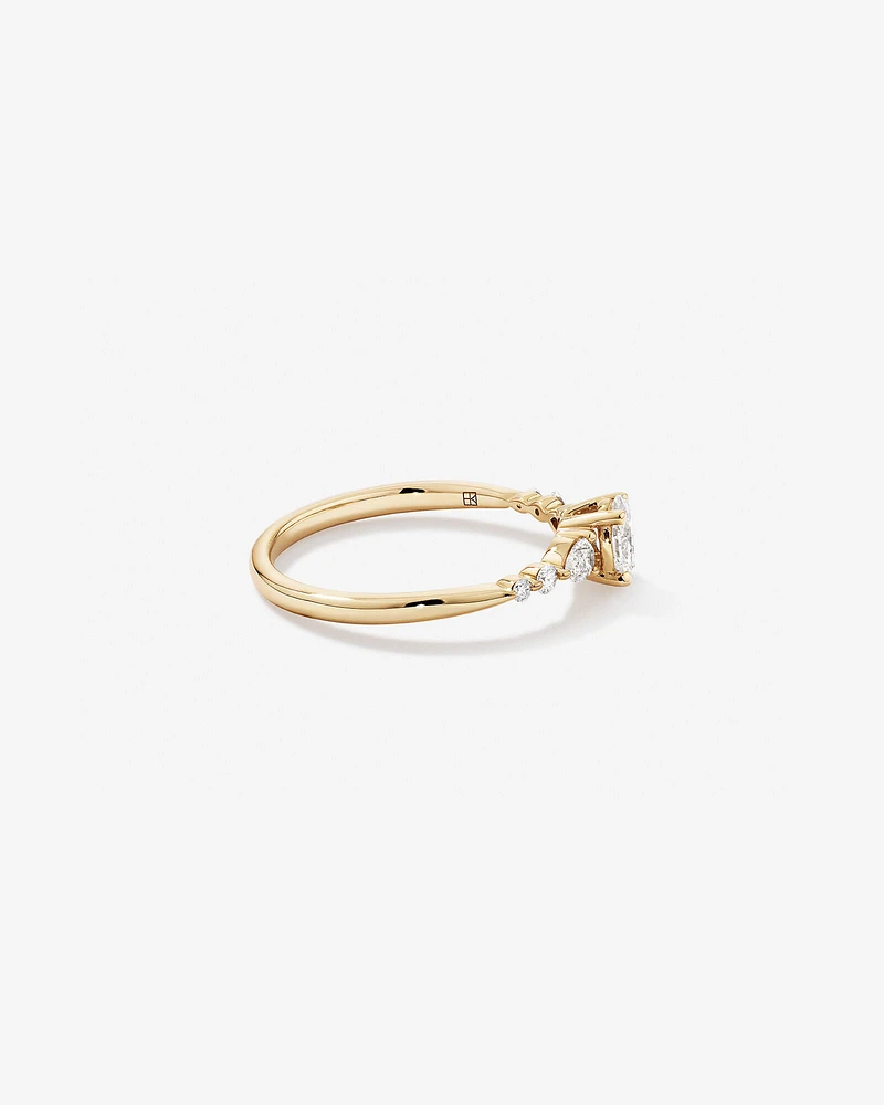 0.59 Carat TW Oval and Pear Sidestone Engagement Ring in 14kt Yellow Gold