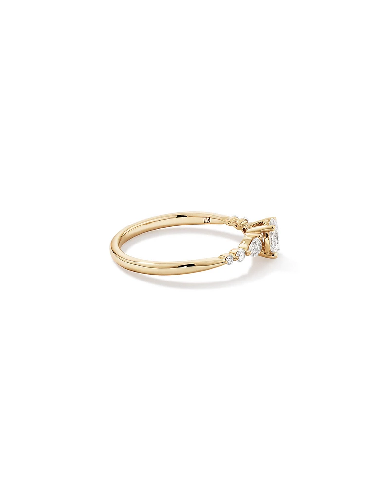 0.59 Carat TW Oval and Pear Sidestone Engagement Ring in 14kt Yellow Gold
