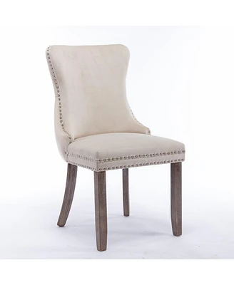 2 Beige Wingback Dining Chairs with Nailhead Trim & Wood Legs