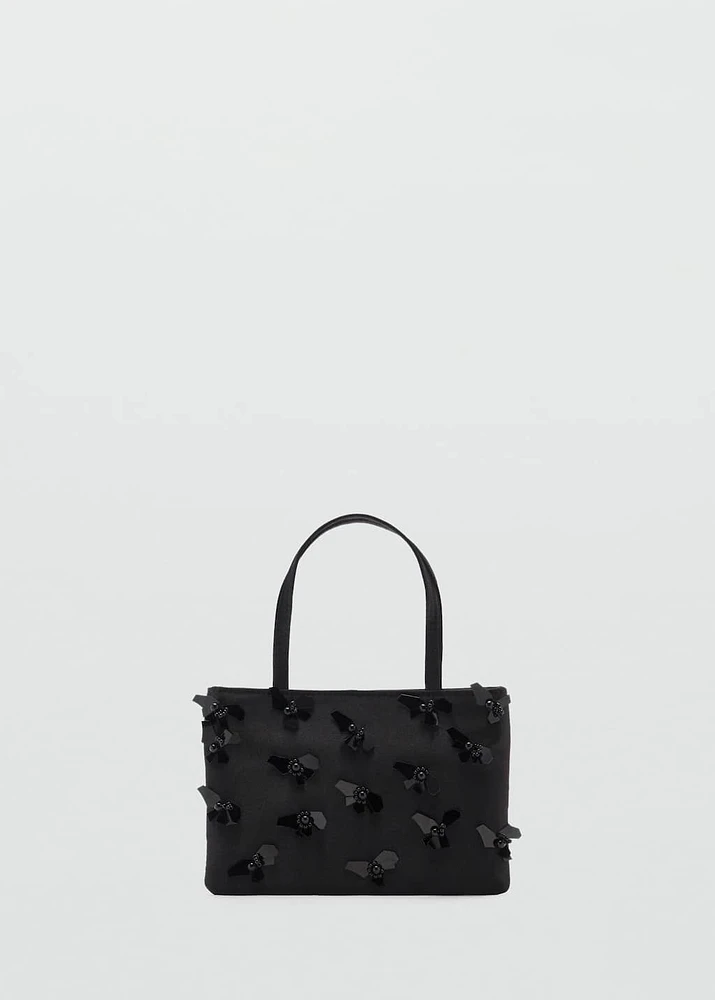 Handbag with flower appliqué