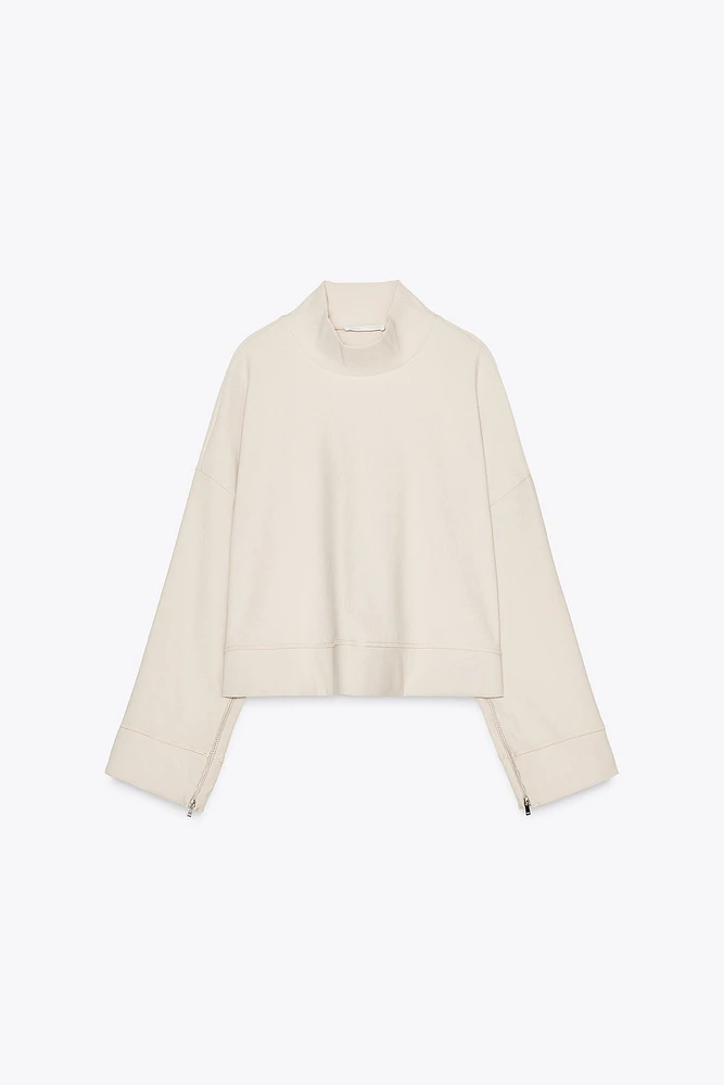 TOP VOLUMINEUX À ZIP