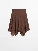 Flowing check skirt with asymmetric hem