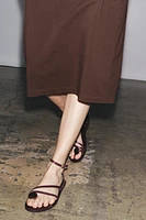 FLAT LEATHER SANDALS WITH DECORATIVE STRAPS