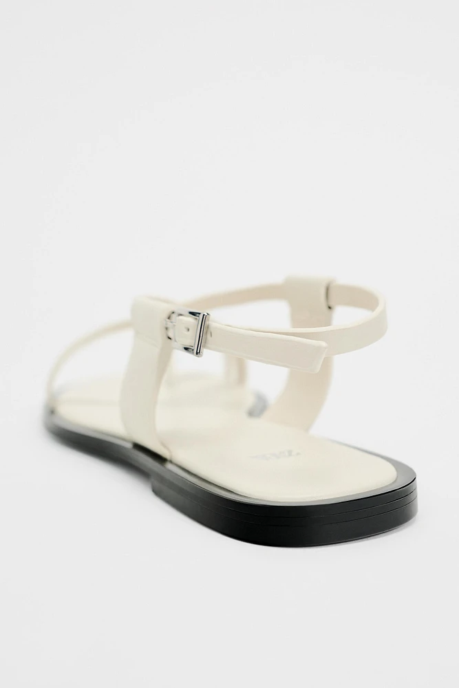 FLAT STRAPPY SANDALS WITH METAL ORNAMENT