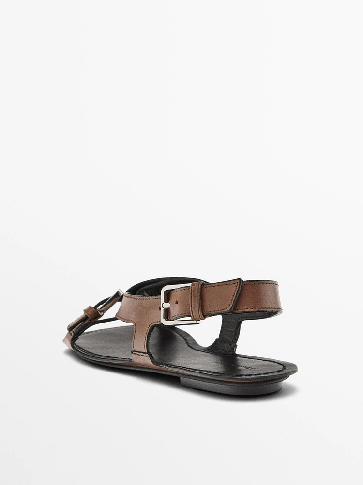 Flat leather sandals with buckles