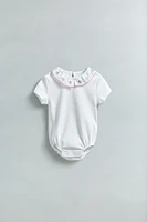 EMBROIDERED NECK BODYSUIT