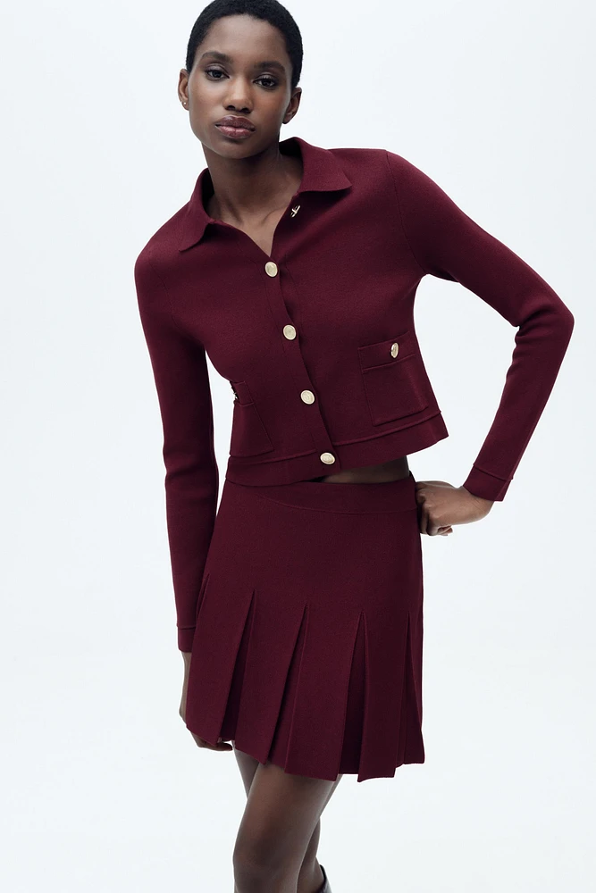 GILET EN MAILLE À BOUTON DORÉ