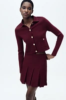 GILET EN MAILLE À BOUTON DORÉ