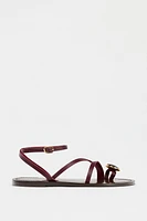 FLAT LEATHER SANDALS WITH DECORATIVE STRAPS