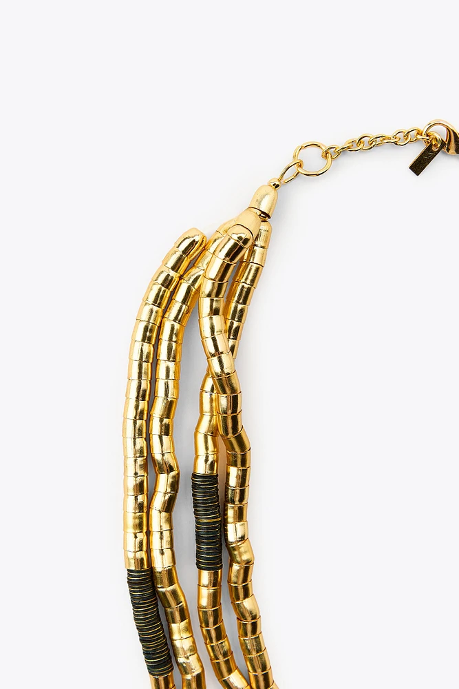 NECKLACE WITH MULTIPLE COMBINED PIECES