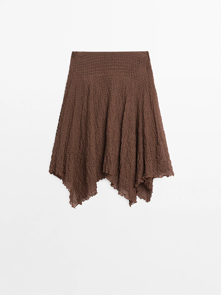 Flowing check skirt with asymmetric hem