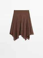 Flowing check skirt with asymmetric hem