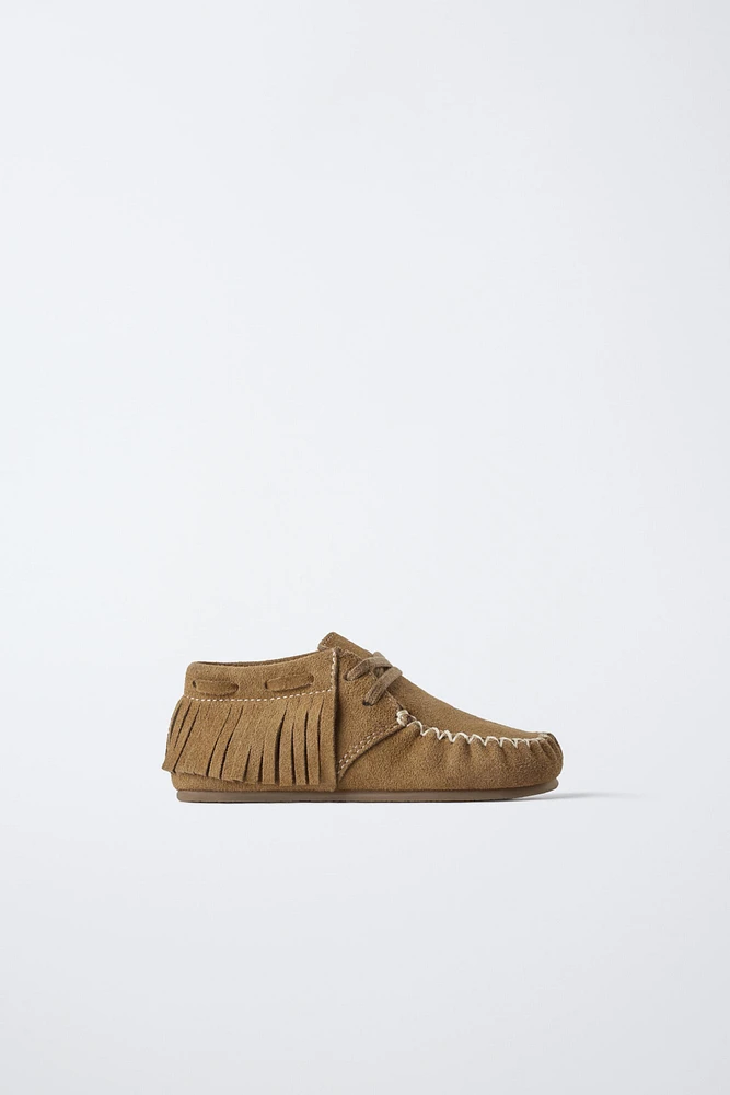 BOTTES EN CUIR À FRANGES
